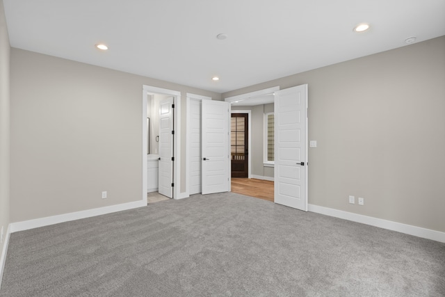 1139 W 22nd St, Houston, TX 77008 - unfurnished bedroom with light colored carpet, recessed lighting, baseboards, and connected bathroom