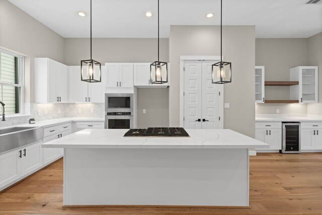 1139 W 22nd St, Houston, TX 77008 - kitchen with wine cooler, stainless steel appliances, a sink, open shelves, and white cabinetry