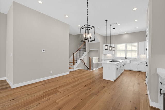 1139 W 22nd St, Houston, TX 77008 - kitchen featuring a chandelier, white cabinetry, light wood-type flooring, light countertops, and recessed lighting