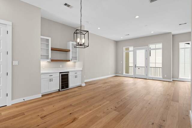 1139 W 22nd St, Houston, TX 77008 - bar featuring wine cooler, baseboards, light wood-style flooring, pendant lighting, and recessed lighting