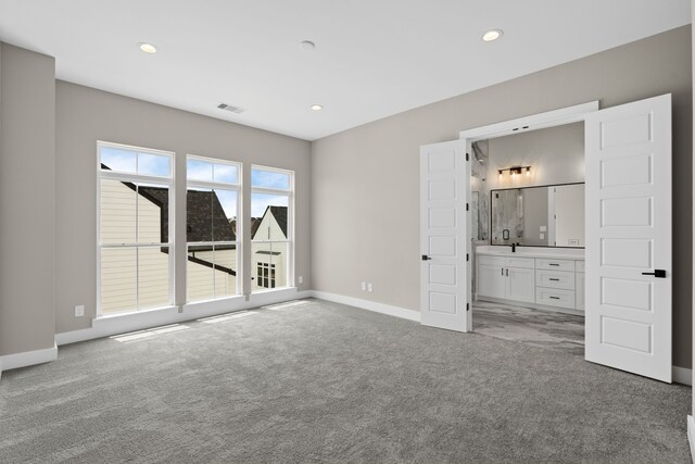 1139 W 22nd St, Houston, TX 77008 - unfurnished bedroom featuring light colored carpet, baseboards, recessed lighting, connected bathroom, and bar