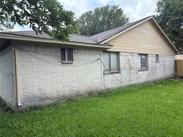 4934 Deerwood Cir, Baytown, TX 77521 - view of home's exterior with brick siding, a lawn, and a shingled roof