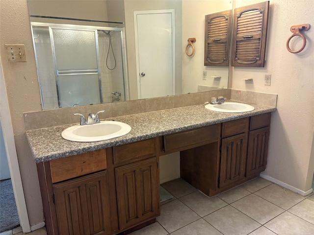 4934 Deerwood Cir, Baytown, TX 77521 - full bath with double vanity, a shower stall, tile patterned floors, and baseboards