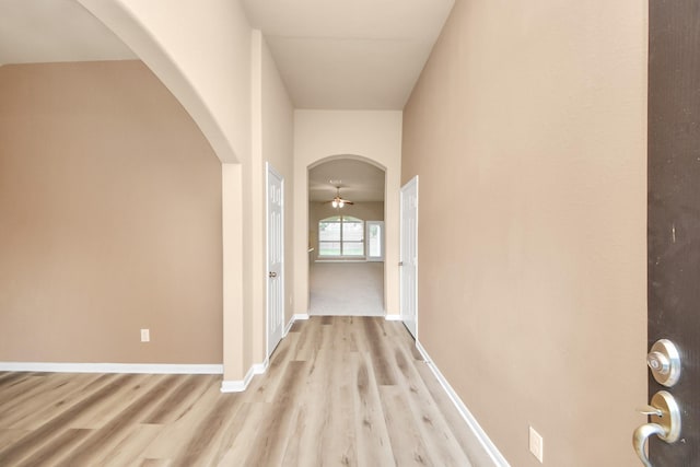 7315 Palmito Ranch Dr, Richmond, TX 77406 - hall with arched walkways, light wood-type flooring, and baseboards