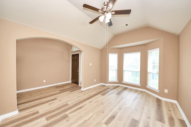 7315 Palmito Ranch Dr, Richmond, TX 77406 - empty room featuring light wood-style floors, vaulted ceiling, ceiling fan, baseboards, and arched walkways