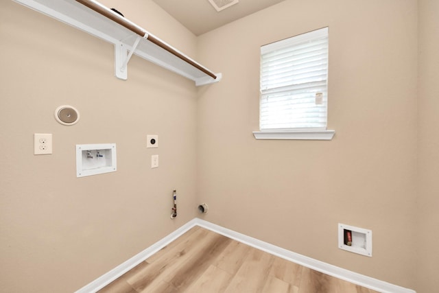 7315 Palmito Ranch Dr, Richmond, TX 77406 - washroom with hookup for a gas dryer, washer hookup, light wood-style flooring, baseboards, and electric dryer hookup