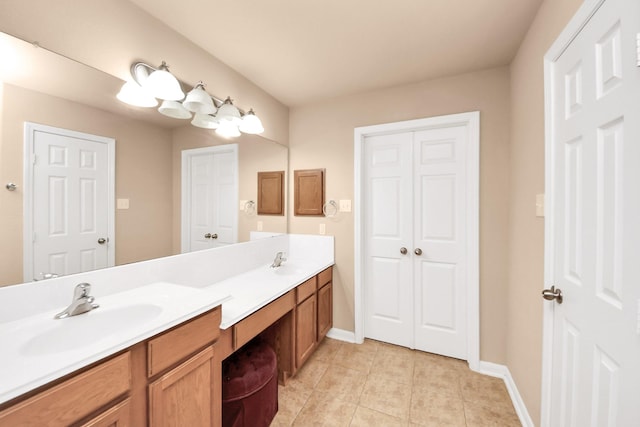 7315 Palmito Ranch Dr, Richmond, TX 77406 - bathroom featuring double vanity, tile patterned floors, baseboards, and a closet