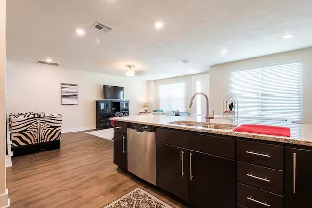 442 William D Fitch, College Station, TX 77845 - kitchen with stainless steel dishwasher, a sink, wood finished floors, open floor plan, and light stone counters