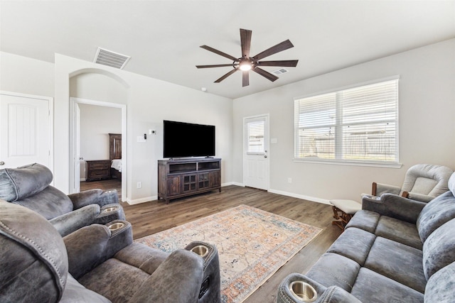 3685 Cub Dr, Conroe, TX 77301 - living area featuring a ceiling fan, wood finished floors, baseboards, and arched walkways