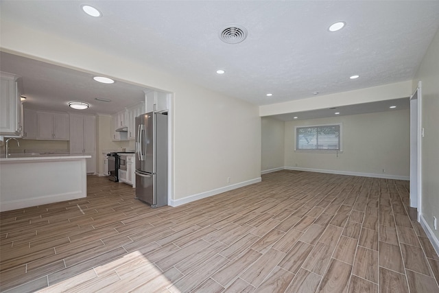 7130 Walkway St, Houston, TX 77036 - unfurnished living room with light wood-style flooring, baseboards, and recessed lighting