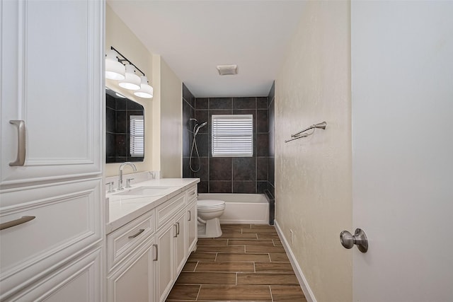 7130 Walkway St, Houston, TX 77036 - bathroom with vanity, toilet, wood finish floors, shower / bath combination, and baseboards