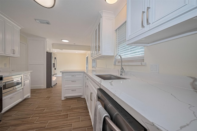 7130 Walkway St, Houston, TX 77036 - kitchen with a sink, stainless steel appliances, white cabinets, dark wood-style floors, and recessed lighting