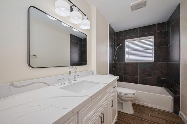 7130 Walkway St, Houston, TX 77036 - full bathroom with wood tiled floors, vanity, toilet, and shower / washtub combination