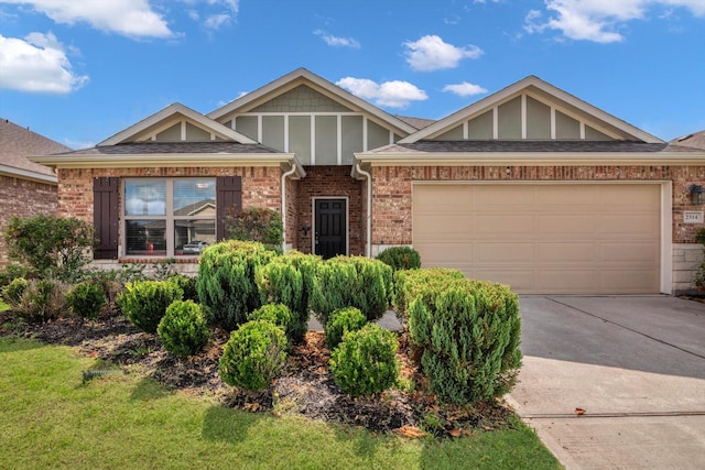 2314 Brickfielder Ln, Baytown, TX 77523 - view of front of property with driveway, brick siding, a garage, and a shingled roof