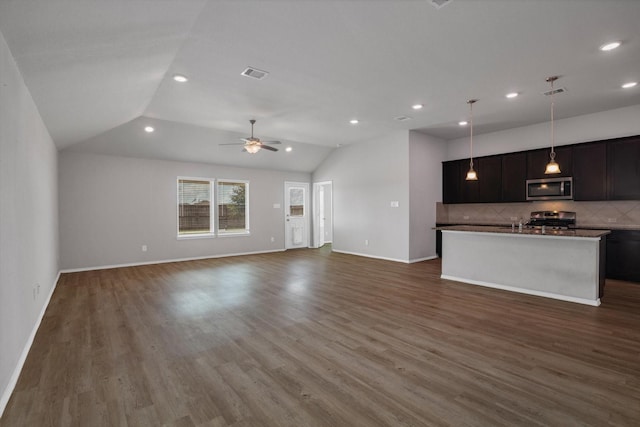 2314 Brickfielder Ln, Baytown, TX 77523 - unfurnished living room featuring recessed lighting, vaulted ceiling, a ceiling fan, and dark wood-style floors