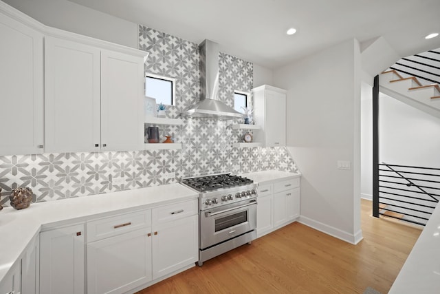 828 Wakefield Dr Unit B, Houston, TX 77018 - kitchen featuring stainless steel stove, wall chimney range hood, open shelves, light wood finished floors, and white cabinets
