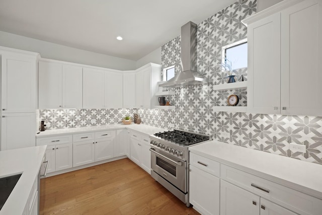 828 Wakefield Dr Unit B, Houston, TX 77018 - kitchen with high end stainless steel range oven, wall chimney range hood, white cabinets, and recessed lighting