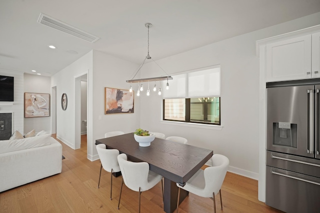 828 Wakefield Dr Unit B, Houston, TX 77018 - dining room featuring baseboards, light wood-style flooring, recessed lighting, and a fireplace