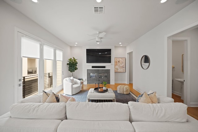 828 Wakefield Dr Unit B, Houston, TX 77018 - living area featuring a ceiling fan, recessed lighting, a fireplace, wood finished floors, and baseboards