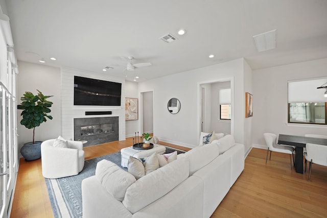 828 Wakefield Dr Unit B, Houston, TX 77018 - living room featuring a large fireplace, a ceiling fan, light wood-style flooring, recessed lighting, and baseboards