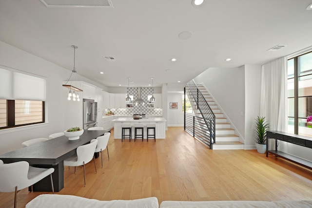 828 Wakefield Dr Unit B, Houston, TX 77018 - dining space with light wood finished floors, stairs, recessed lighting, and baseboards