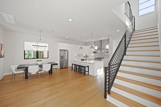 828 Wakefield Dr Unit B, Houston, TX 77018 - stairs with wood finished floors, recessed lighting, and baseboards