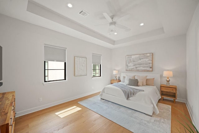 828 Wakefield Dr Unit B, Houston, TX 77018 - bedroom with a raised ceiling, baseboards, recessed lighting, light wood-type flooring, and ceiling fan