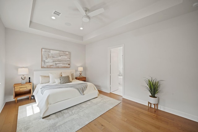 828 Wakefield Dr Unit B, Houston, TX 77018 - bedroom with wood finished floors, a raised ceiling, baseboards, and recessed lighting
