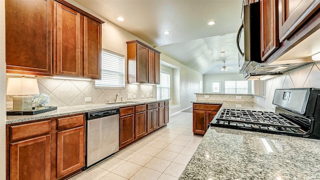 32706 Oak Heights Ln, Brookshire, TX 77423 - kitchen with stainless steel appliances, ceiling fan, a sink, light tile patterned floors, and tasteful backsplash