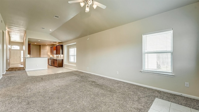 32706 Oak Heights Ln, Brookshire, TX 77423 - unfurnished living room featuring light tile patterned flooring, ceiling fan, vaulted ceiling, light carpet, and baseboards