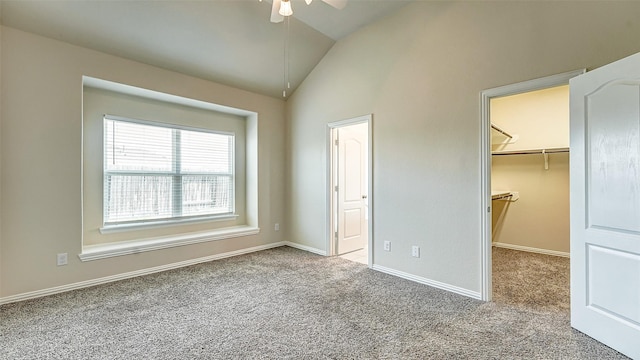 32706 Oak Heights Ln, Brookshire, TX 77423 - unfurnished bedroom with lofted ceiling, carpet floors, a walk in closet, baseboards, and a closet