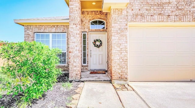 32706 Oak Heights Ln, Brookshire, TX 77423 - property entrance featuring a garage, driveway, and brick siding