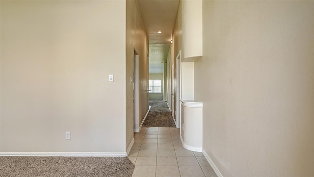 32706 Oak Heights Ln, Brookshire, TX 77423 - hallway featuring light tile patterned floors, baseboards, and light carpet