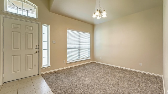 32706 Oak Heights Ln, Brookshire, TX 77423 - foyer entrance featuring a chandelier, light tile patterned floors, baseboards, and light carpet