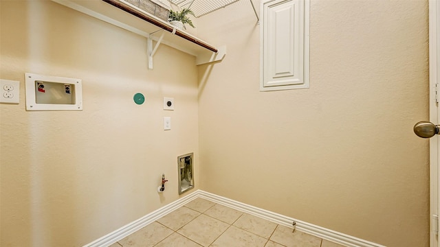 32706 Oak Heights Ln, Brookshire, TX 77423 - laundry area with hookup for an electric dryer, gas dryer hookup, light tile patterned floors, washer hookup, and baseboards