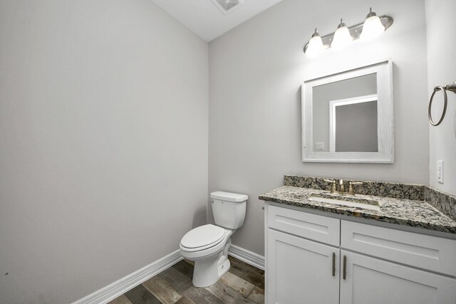 25450 Killarney St, Hempstead, TX 77445 - half bath featuring wood finished floors, vanity, toilet, and baseboards