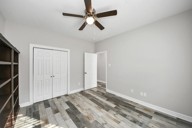 25450 Killarney St, Hempstead, TX 77445 - unfurnished bedroom with wood finished floors, a closet, baseboards, and a ceiling fan