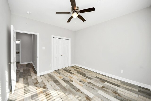 25450 Killarney St, Hempstead, TX 77445 - unfurnished bedroom featuring wood finished floors, a closet, baseboards, and a ceiling fan