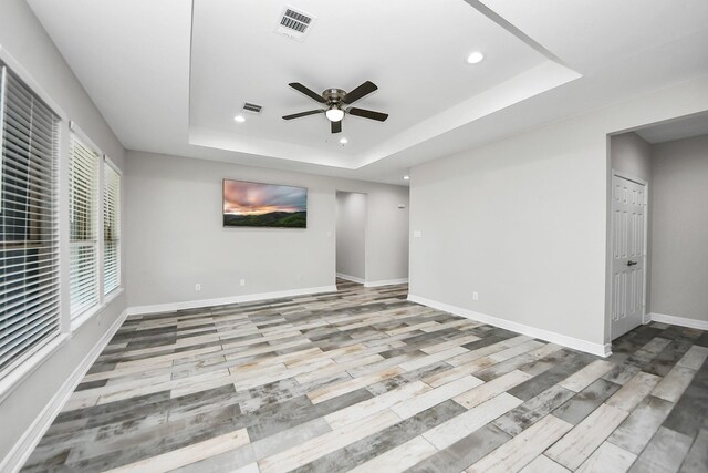 25450 Killarney St, Hempstead, TX 77445 - unfurnished room featuring a tray ceiling, recessed lighting, ceiling fan, baseboards, and wood finished floors