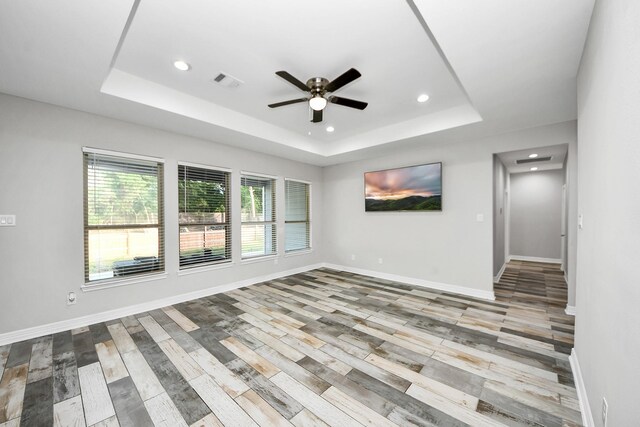 25450 Killarney St, Hempstead, TX 77445 - spare room featuring a raised ceiling, a ceiling fan, recessed lighting, baseboards, and wood finished floors