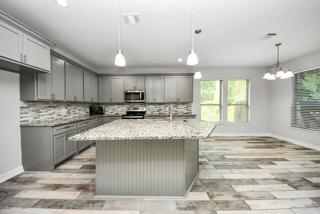 25450 Killarney St, Hempstead, TX 77445 - kitchen featuring gray cabinetry, appliances with stainless steel finishes, tasteful backsplash, baseboards, and recessed lighting