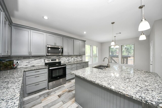 25450 Killarney St, Hempstead, TX 77445 - kitchen with appliances with stainless steel finishes, gray cabinets, a sink, backsplash, and recessed lighting