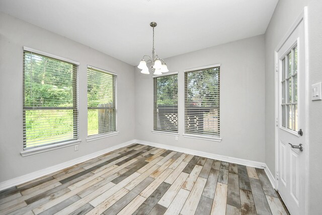 25450 Killarney St, Hempstead, TX 77445 - spare room featuring a chandelier, wood finished floors, and baseboards