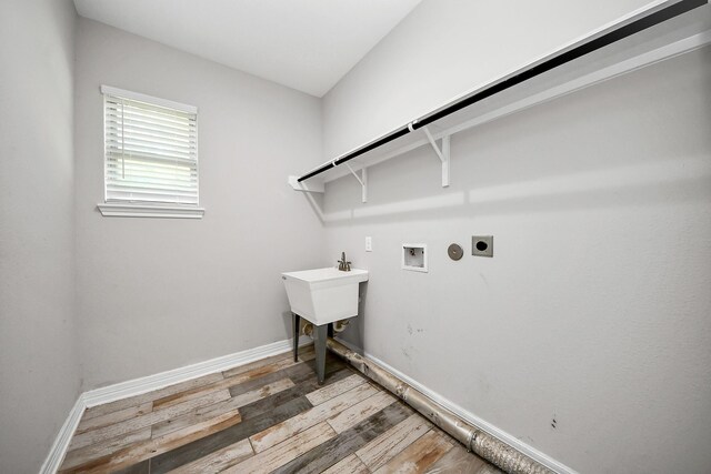 25450 Killarney St, Hempstead, TX 77445 - laundry area featuring hookup for an electric dryer, light wood-style flooring, washer hookup, and baseboards