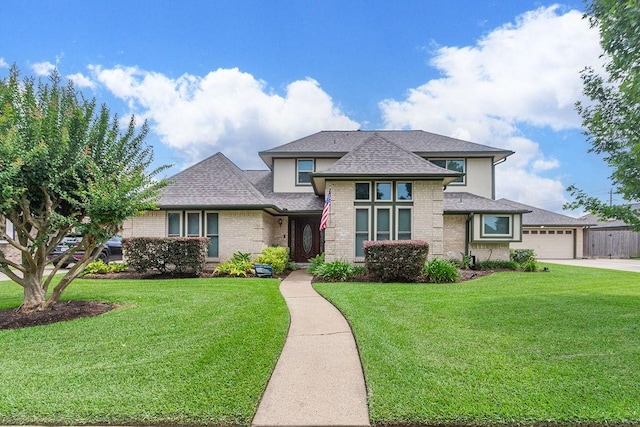 6310 Gleneagles Dr, Pasadena, TX 77505 - prairie-style house with a front lawn, brick siding, roof with shingles, and a garage