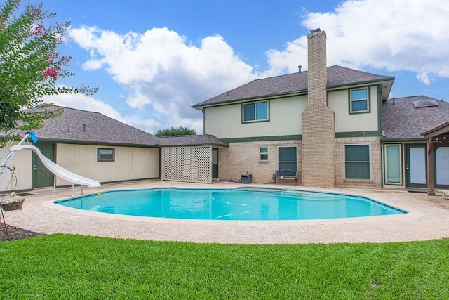 6310 Gleneagles Dr, Pasadena, TX 77505 - outdoor pool with a water slide, a patio area, and a yard