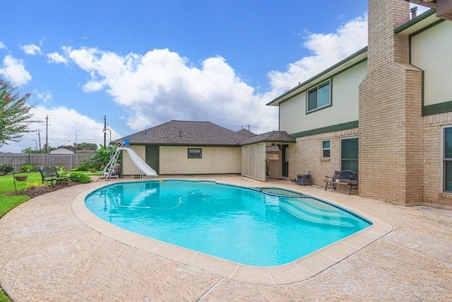 6310 Gleneagles Dr, Pasadena, TX 77505 - view of swimming pool with a patio area, a water slide, and a pool with connected hot tub