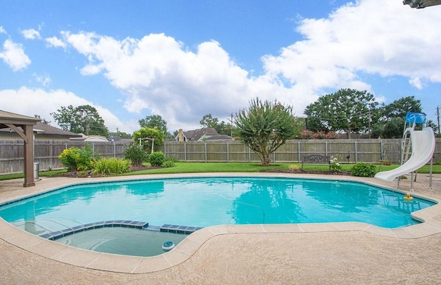 6310 Gleneagles Dr, Pasadena, TX 77505 - view of swimming pool featuring a water slide, a fenced backyard, a patio, and a pool with connected hot tub