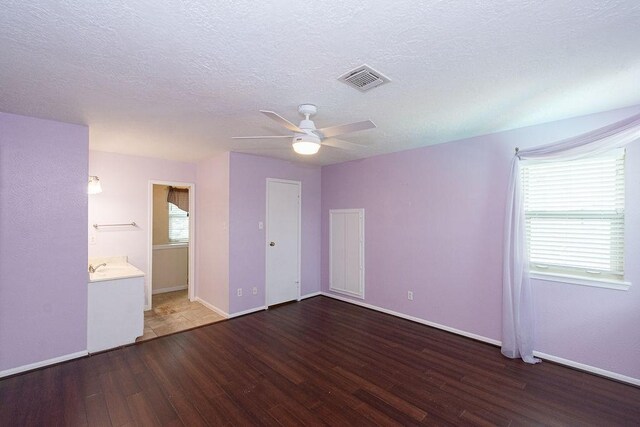 6310 Gleneagles Dr, Pasadena, TX 77505 - unfurnished bedroom featuring wood finished floors, a textured ceiling, and ceiling fan