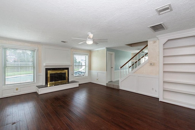 6310 Gleneagles Dr, Pasadena, TX 77505 - unfurnished living room with stairway, hardwood / wood-style flooring, a textured ceiling, a decorative wall, and a ceiling fan